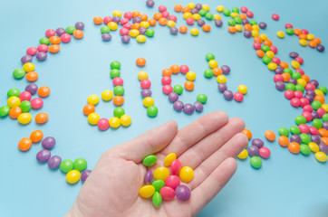 candy caramel lined word diet, on blue background, closeup