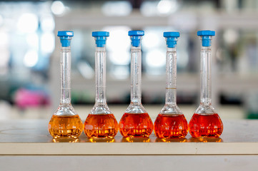 red-orange solution in cyliner flask