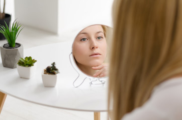 Woman Beauty Face Care. Portrait Of Beautiful Happy Young Female With Fresh Healthy Skin Looking In Mirror. Closeup Of Attractive Healthy Smiling Girl With Fresh Natural Face Makeup. 