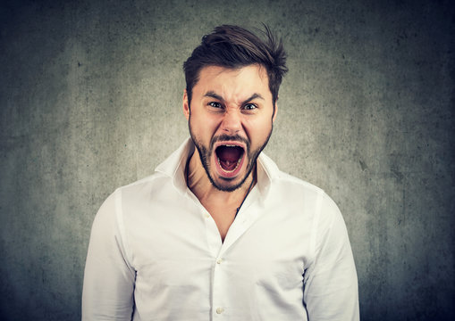 Young man screaming in anger