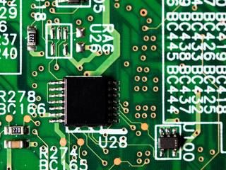 close-up of circuit board with integrated circuits, resistors and capacitors.