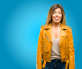 Beautiful young woman sticking out tongue at camera at sign of disobedience, protest and...