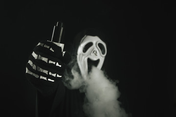 man in a terrible mask and black cloak vape