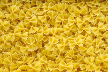 farfalle macaroni background with pasta. A view from the top, a close-up of a texture.