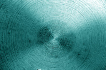 Metal surface with scratches in cyan tone.