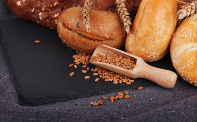 Bakery, crusty loaves of bread and buns. Assortment of baked bread.