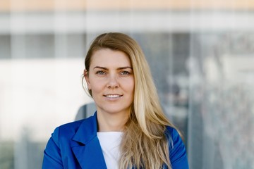 Young elegant business woman in blue jacket.