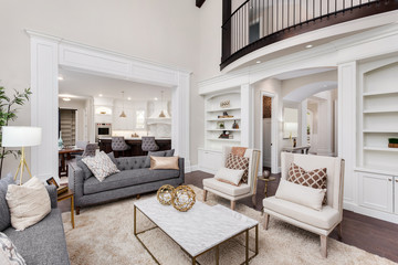 Beautiful living room interior with hardwood floors, view of kitchen and dining room in new luxury home - Powered by Adobe