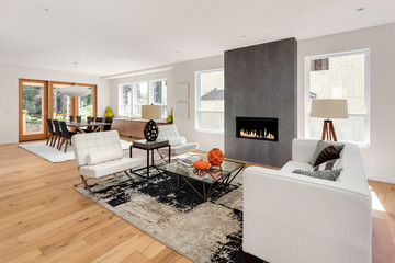 Beautiful Living Room and Fireplace in New Luxury Home. Has Open Floorplan with View of Dining Room