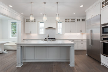 Kitchen Interior in New Lxury Home with Stainless Steel Appliances, Hardwood Floor, and Large Island