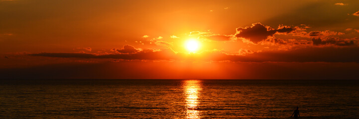 Fototapeta na wymiar panorama of beutiful orange sunset on the calm sea