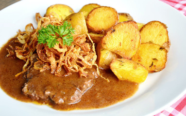 onion-topped roast beef with gravy is the favorite dish in Austria. (German name is Zwiebelrostbraten)
Beef,potatoes and onion menu in European style