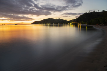 Tropical beach with warm sunlight at dusk time