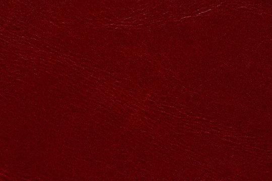 Saturated leather texture in contrast red tone.