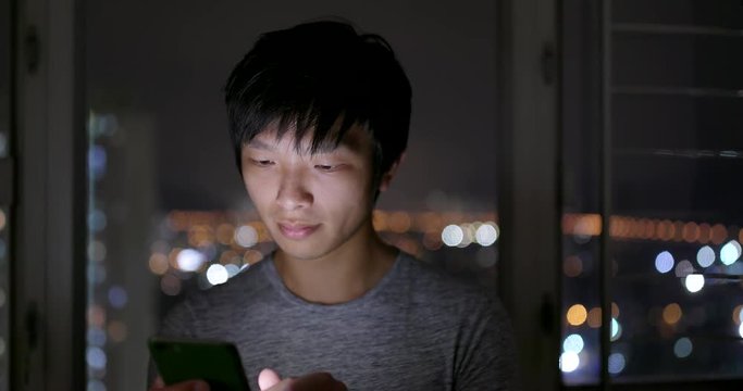 Man use of smart phone at home in the evening
