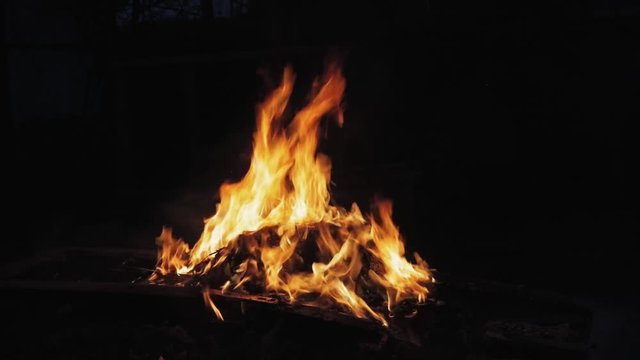 Fire burning against dark isolated background
