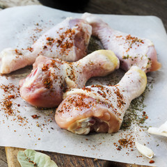 Raw chicken legs with spices