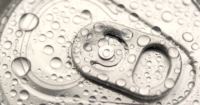 Water droplets on can of soda or beer in rotation