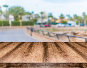 Wooden empty table board in front of blurred background. Can be used for display or montage any product. Mock up for display your product.