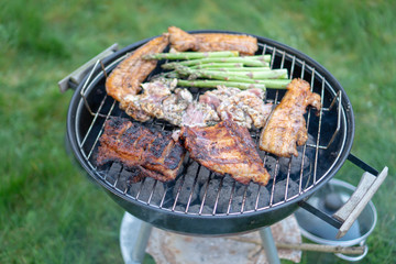 Barbecue Grill - Grilled chicken , Pork, spare ribs, sausage and vegetables asparagus on the Grill
