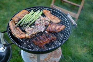 Barbecue Grill - Grilled chicken , Pork, spare ribs, sausage and vegetables asparagus on the Grill
