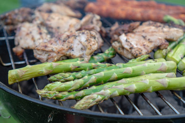 Barbecue Grill - Grilled chicken , Pork, spare ribs, sausage and vegetables asparagus on the Grill