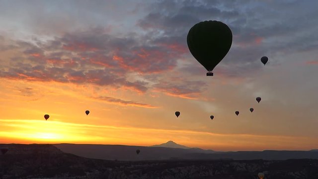 Silhouette of Hot Air Balloons Flying Over Cappadocia at Sunrise
