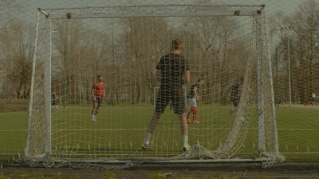 Young soccer players dribbling, bringing soccer ball past defenders and creating opportunities to score during football match. Footballer performing dribbles and feints to go past an opponent in pitch