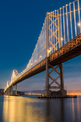 Fototapeta na wymiar Under the Bay Bridge Light Reflections. The Embarcadero, San Francisco, California, USA.