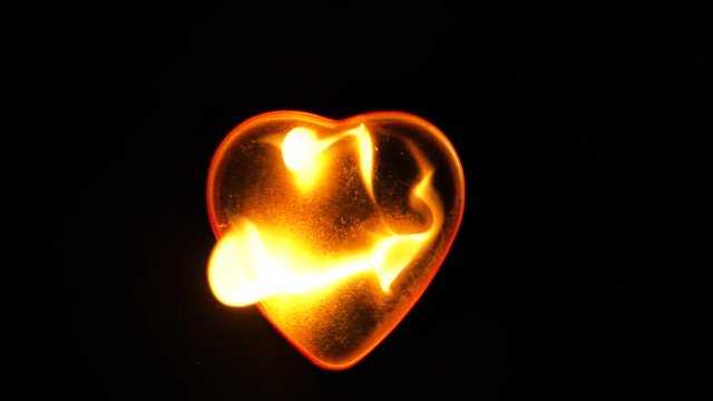 Concept idea: Burning heart in slow motion on black background