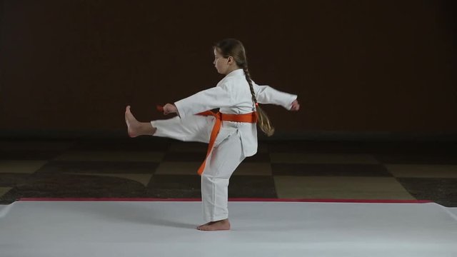 Direct kicks the girl is training in karategi