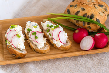 Light healthy sandwiches with soft cheese, radish and chives