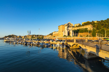 Seascape with Ancona harbor and boat docked at sunset, Marche, Italy