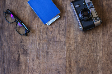Flat lay design of work desk with notebook, glasses, camera on white background.