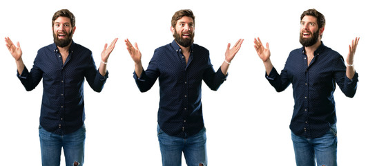 Young man with beard happy and surprised cheering expressing wow gesture isolated over white background