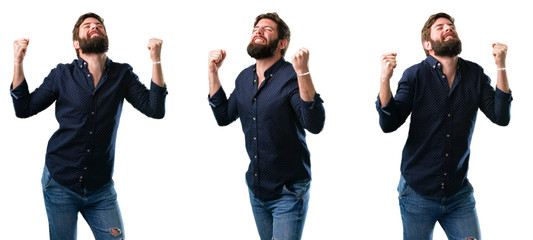 Young man with beard happy and excited expressing winning gesture. Successful and celebrating victory, triumphant isolated over white background