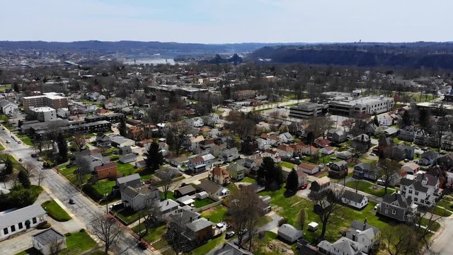 A daytime slow forward aerial establishing shot of a typical residential neighborhood in a Pennsylvania Ohio Valley small town. Pittsburgh suburbs.  	