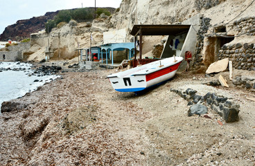 Fototapeta na wymiar Fishing house and boat in Red beach Athens Greece