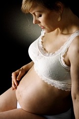 pregnant woman holding her tummy