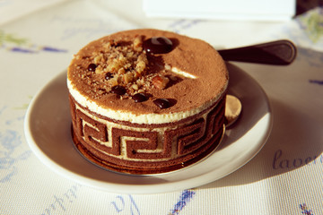 Beautiful round chocolate cake with decorations in a cafe, food party menu background