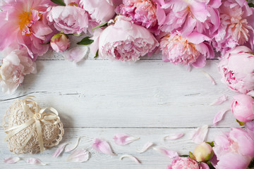Background with pink peonies and a lacy heart for congratulations