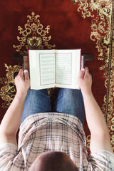 Muslim man reading Islamic holy book quran