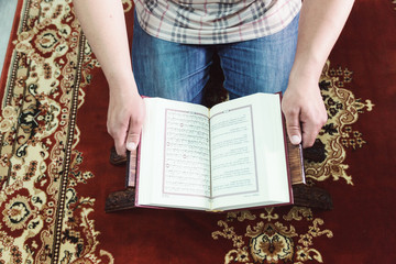 Muslim man reading Islamic holy book quran