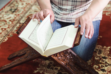 Muslim man reading Islamic holy book quran