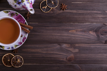 Teapot tea cup on brown wooden table.