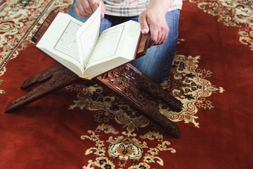 Muslim man reading Islamic holy book quran