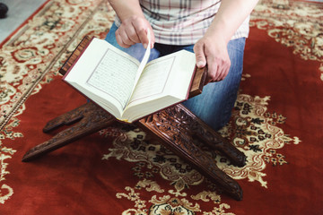 Muslim man reading Islamic holy book quran