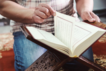 Muslim man reading Islamic holy book quran