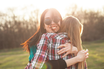 Two best friends having fun outdoors at sunset.