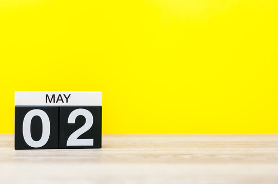 May 2nd. Day 2 of may month, calendar on office table with yellow background. Spring time